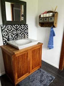 a bathroom with a sink and a mirror at Rainbow Mountain cottage in Rotorua