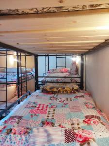 a bedroom with two bunk beds with a quilt at Youth Palace Hostel هوستل قصر الشباب in Alexandria