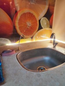 a sink with a bunch of oranges in the background at Youth Palace Hostel هوستل قصر الشباب in Alexandria