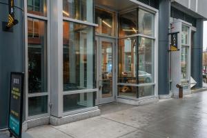 a store front with glass doors on a city street at Industrial 1BR nr MIT w Gym Doorman Roof BOS-37 in Cambridge