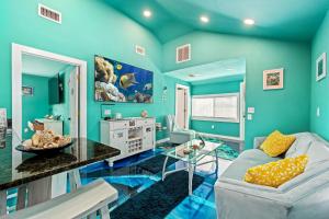 a blue living room with a couch and a table at Above The Sea in St. Petersburg