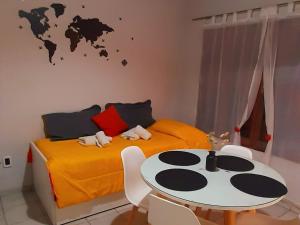 a bedroom with a bed and a table and a world map on the wall at APART CENTRO RIOJA, Zona Residencial, Parking privado gratis a 100 mts in Mendoza