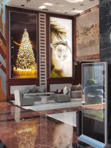 a living room with a christmas tree and a couch at Social Hotel formerly Byblos in Dubai