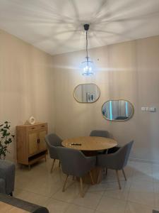 a dining room with a wooden table and chairs at Marbella Grand Holiday Homes - Al Nahda 1 in Dubai