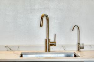 a kitchen sink with two faucets on a counter at Villa Pura Vida in Denia