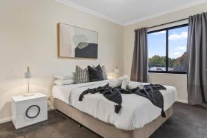 a bedroom with a large bed and a window at Luxury Retreat in the Heart of Subiaco in Perth