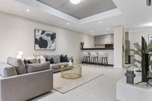 a living room with a couch and a table at Luxury Retreat in the Heart of Subiaco in Perth
