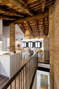 a kitchen and dining room of a house with wooden ceilings at L’Angorfa de Casa Santiago, casa rural in Tivenys