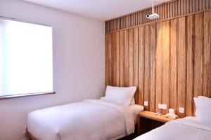 Ένα ή περισσότερα κρεβάτια σε δωμάτιο στο Hantang Inn Hostel Xi'an