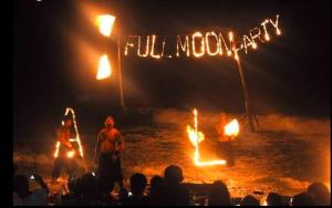 a group of people watching a fire show at night at Siri medura surf yoga meditation guesthouse and hostel in Weligama