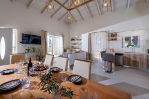 a kitchen and dining room with a table and chairs at Villa Niragia with Magnificent view in Astérion
