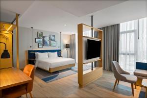 バルケスィルにあるHilton Garden Inn Balikesirのベッドとテレビがあるホテルの部屋
