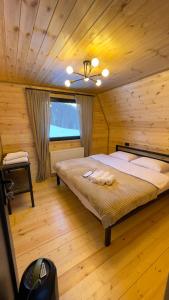 a bedroom with a bed in a wooden cabin at view in Stepantsminda