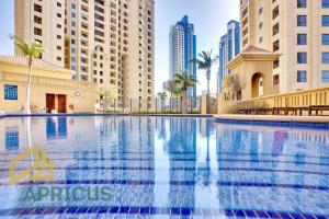 a swimming pool in a city with tall buildings at Wonderful 2BD apartment near The Beach Sadaf JBR in Dubai