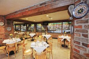 a restaurant with tables and chairs and a brick wall at Hotel PF in Mexico City