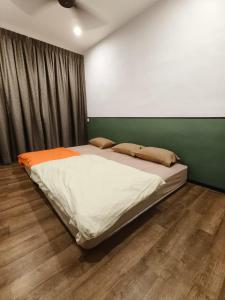 Wellson Home Ipoh14px 怡保中古风5间房民宿 في ايبوه: سرير كبير في غرفة بجدار أخضر