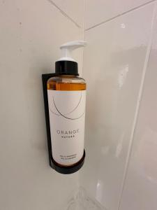 a bottle of orange hand soap sitting on a wall at Paseo Tenorio, remanso de paz con PISCINA in Ezcaray +22 photos