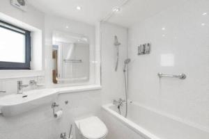 a white bathroom with a toilet and a sink at Gorgeous old town Hideaway in Edinburgh