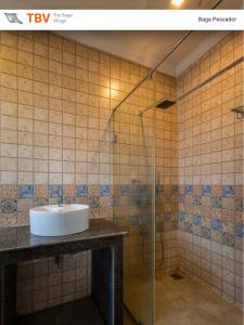 a bathroom with a sink and a shower at The Baga Pescador-TBV in Baga