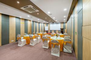 a conference room with tables and chairs and a podium at WESTSIDE HOTEL HiTECH CITY in Hyderabad +10 photos