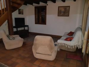 a living room with two chairs and a couch at Maison in Saint-Priest-de-Gimel