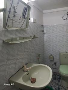 y baño con lavabo, espejo y aseo. en Amith Villa Kabalana, en Koggala