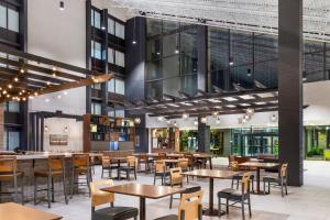 a dining room with tables and chairs and a building at Candlewood Suites - Roanoke Airport in Roanoke