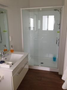 a bathroom with a shower with a glass door at Baywaterviews in Paihia