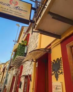 a building with a sign on the side of it at B&B Rampante in Piana degli Albanesi