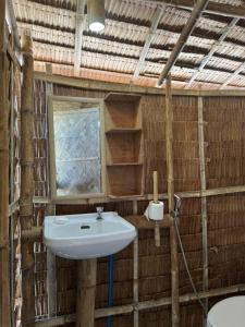 a bathroom with a sink and a window at Bice Camp Darocotan in El Nido