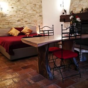 a table and chairs in a room with a bed at Féerie Love in Puget-sur Argens