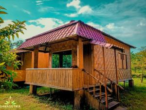 a small wooden house with a dog in it at Sawasstika Eco Park Resort in Binnāguri