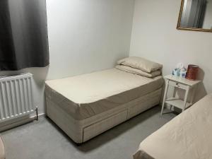 a small bedroom with two beds and a table at Cozy Corner in Birmingham