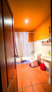 a bathroom with a toilet and a sink at La Fonda de Xiva in Chiva de Morella