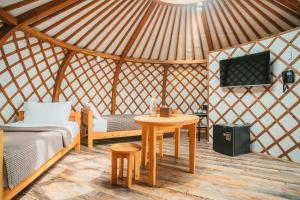 um quarto com uma cama e uma mesa numa tenda em Glory Resort Mongolia em Nalayh