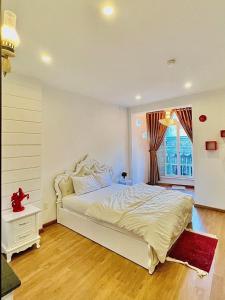 Ένα ή περισσότερα κρεβάτια σε δωμάτιο στο Nha Cua Tao Homestay Quy Nhon - Venuestay