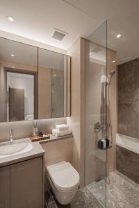 a bathroom with a toilet and a sink and a shower at MarQ Luxury Apartment by NEST Group in Ho Chi Minh City