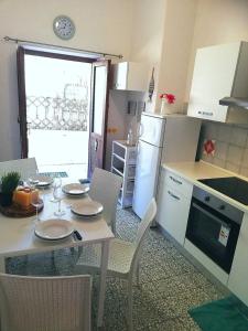 a kitchen with a table and chairs and a kitchen with a table and a table at Ginestra in Campese