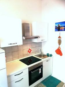 a small kitchen with a sink and a stove at Ginestra in Campese