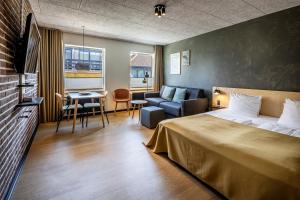 Postel nebo postele na pokoji v ubytování Fjordgaarden - Spa - Hotel - Konference + 37 fotografií