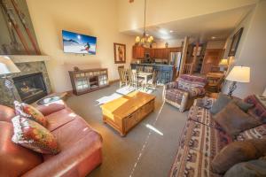 a living room with a couch and a table at Red Hawk Townhomes 2337 in Keystone