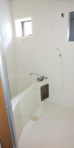 a white bathroom with a shower and a sink at Yagisawa Corp 103 - Vacation STAY 33494v in Nikko