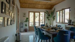 a dining room with a table and blue chairs at Mountain Retreat in Troodos