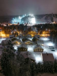 an aerial view of a village at night at Lapland Hotels Ounasvaara Chalets in Rovaniemi
