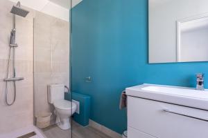 a bathroom with a toilet and a sink and a shower at Le Carrousel - Appartement avec studio attenant in Deauville