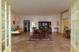 a dining room and living room with a table and chairs at Art Residence Goldener Löwe in Bodman-Ludwigshafen