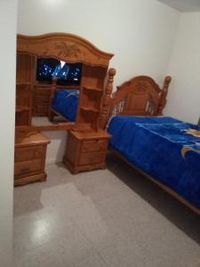 a bedroom with two beds and wooden furniture and a mirror at Hunts Point Short Stays in Hunts Point