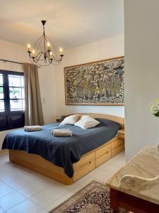 a bedroom with a bed and a chandelier at La Mar Poolvilla in Costa Teguise