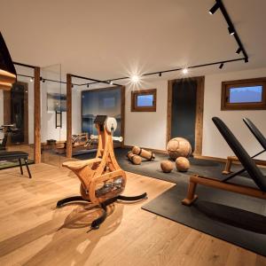 a room with a gym with exercise equipment in it at activechalets six.nine.eight in Reit im Winkl