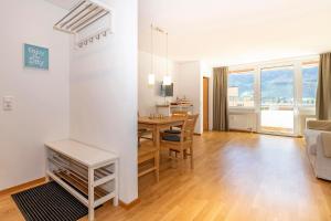 a dining room and living room with a table and a couch at Ferienwohnung Spannring in Schruns